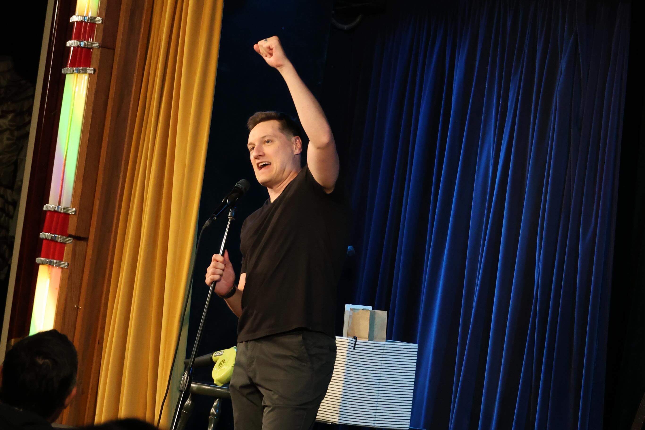 Audience members laughing during a company event performance