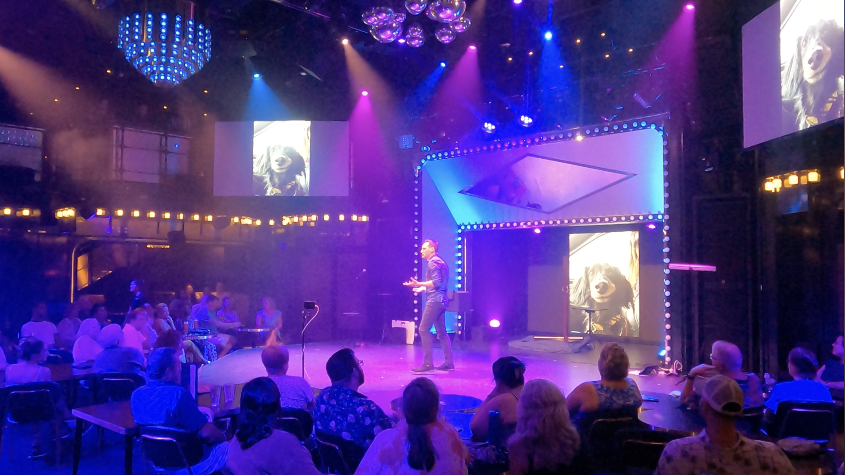 Nick Paul performing on a lit stage at a corporate gala in Michigan
